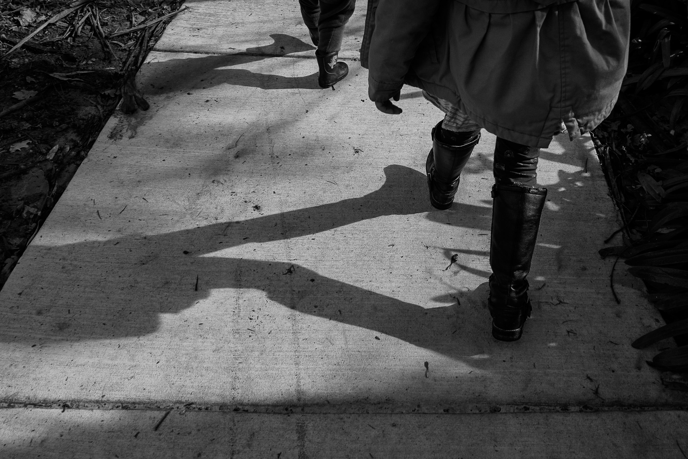 shadows of kids walking along the river in warburton